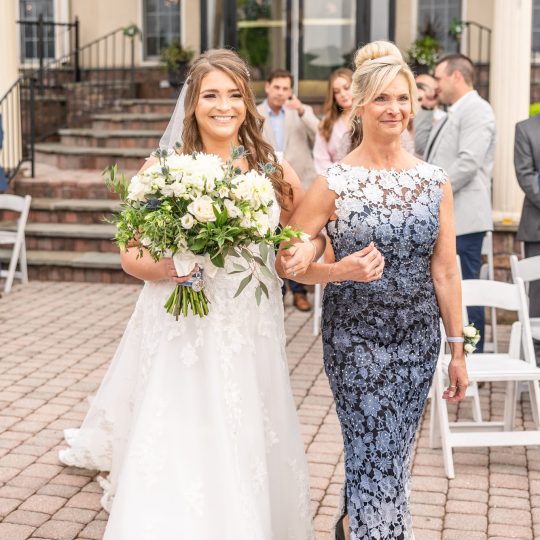 bride and mother walking down aisle bride and mother walking down aisle